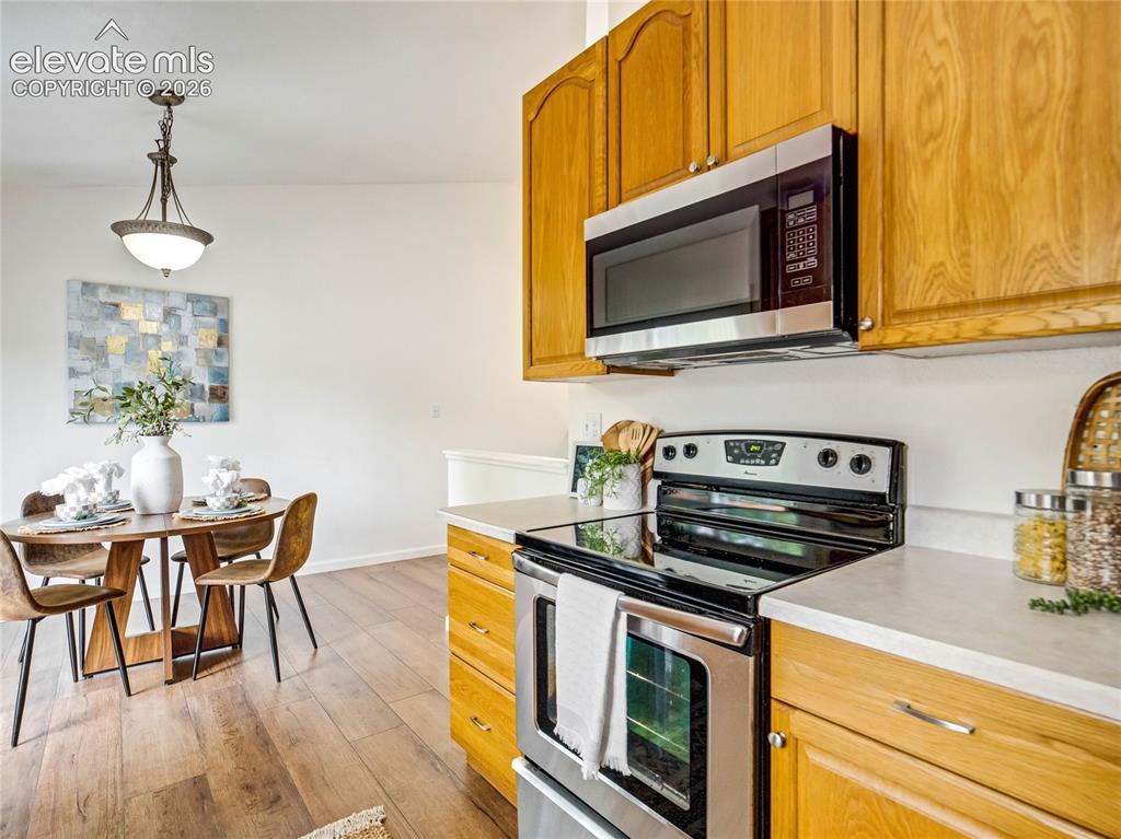 Image 12 of 33: Functional kitchen with ample cabinet storage and an adjoining dining nook 