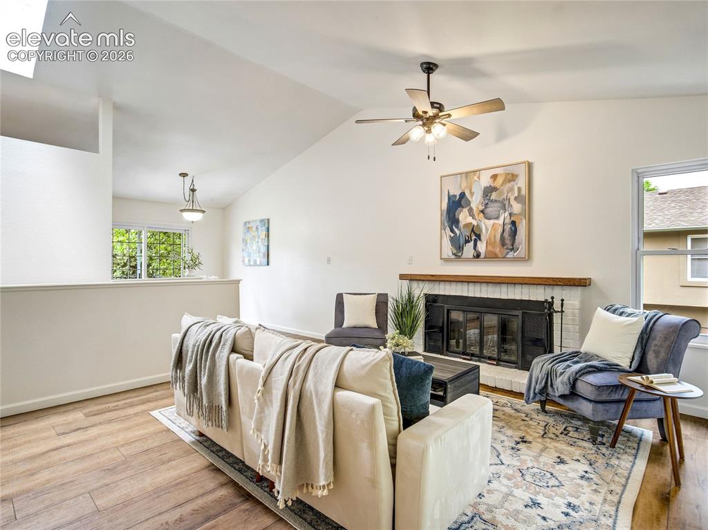 Image 2 of 33: Vaulted ceiling and fresh paint create a light, bright living room
