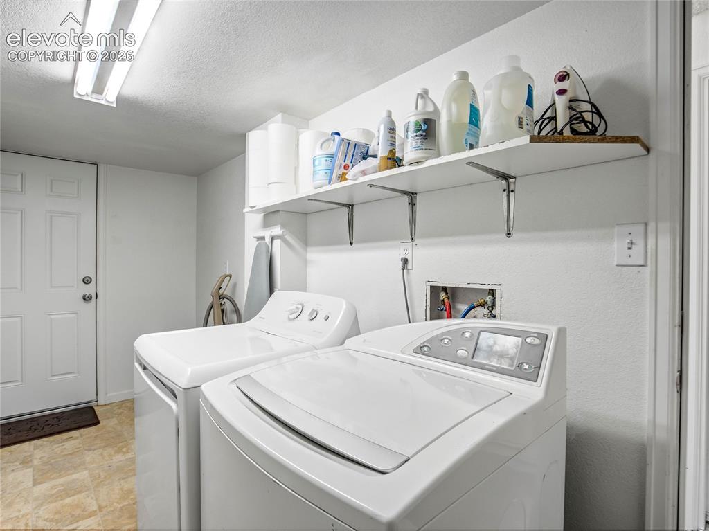 Image 25 of 33: Laundry day is simplified with plenty of additional storage for supplies