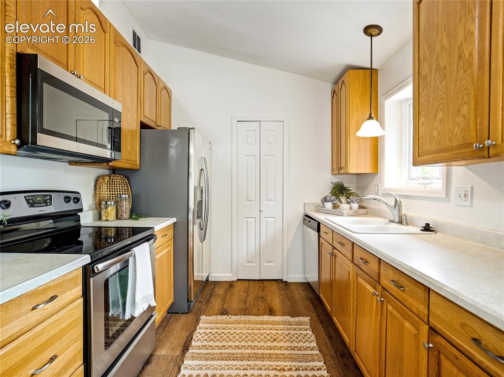 Image 3 of 33: Kitchen is fully equipped with stainless appliances, pantry and west facing