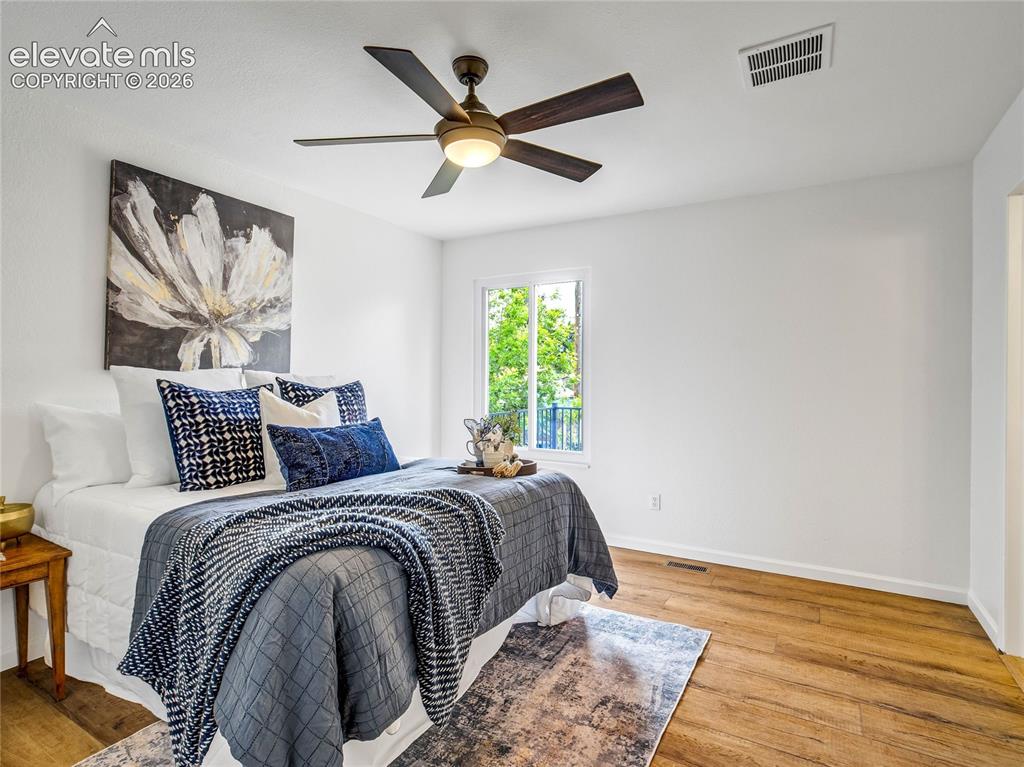 Image 4 of 33: Main-level primary bedroom features luxury vinyl plank flooring, fresh pain