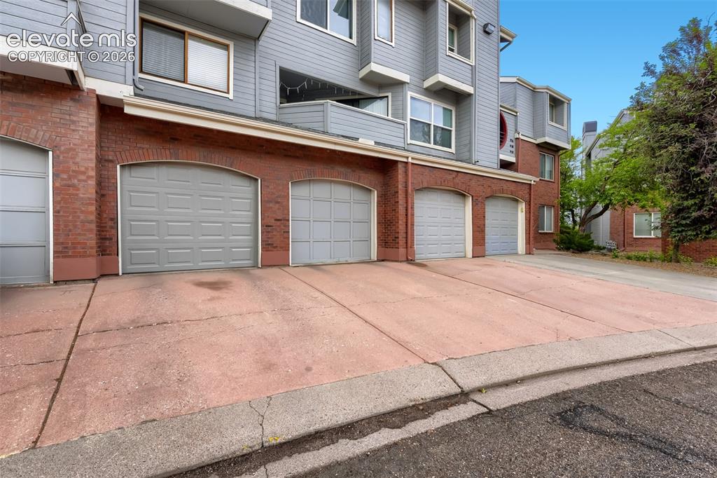 Image 23 of 27: 1 Car garage with parking in front drive way & 1 received spot 