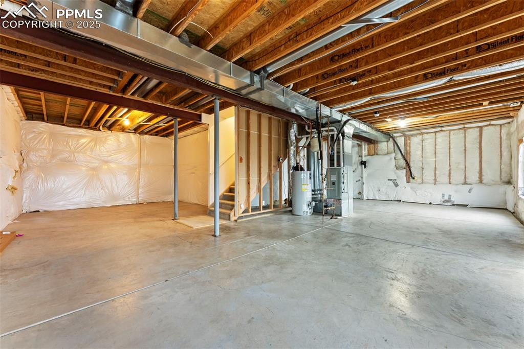 Image 19 of 28: Huge unfinished basement with 9 ft ceilings and endless potential
