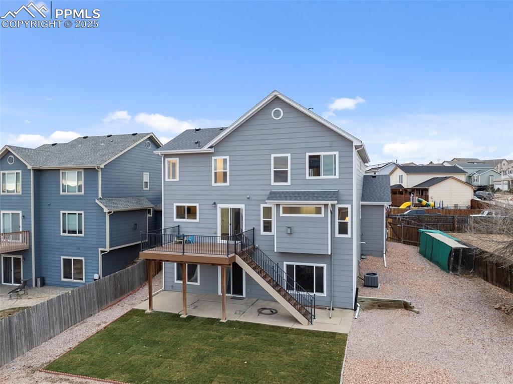 Image 25 of 28: Wide view of the back of the home and full yard