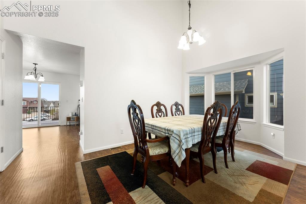 Image 4 of 28: Bright entry dining area with large windows and natural light.