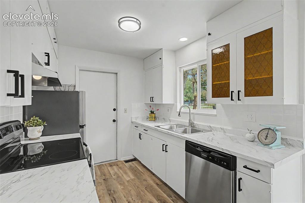 Image 3 of 37: Retro remodeled kitchen with original glass doors