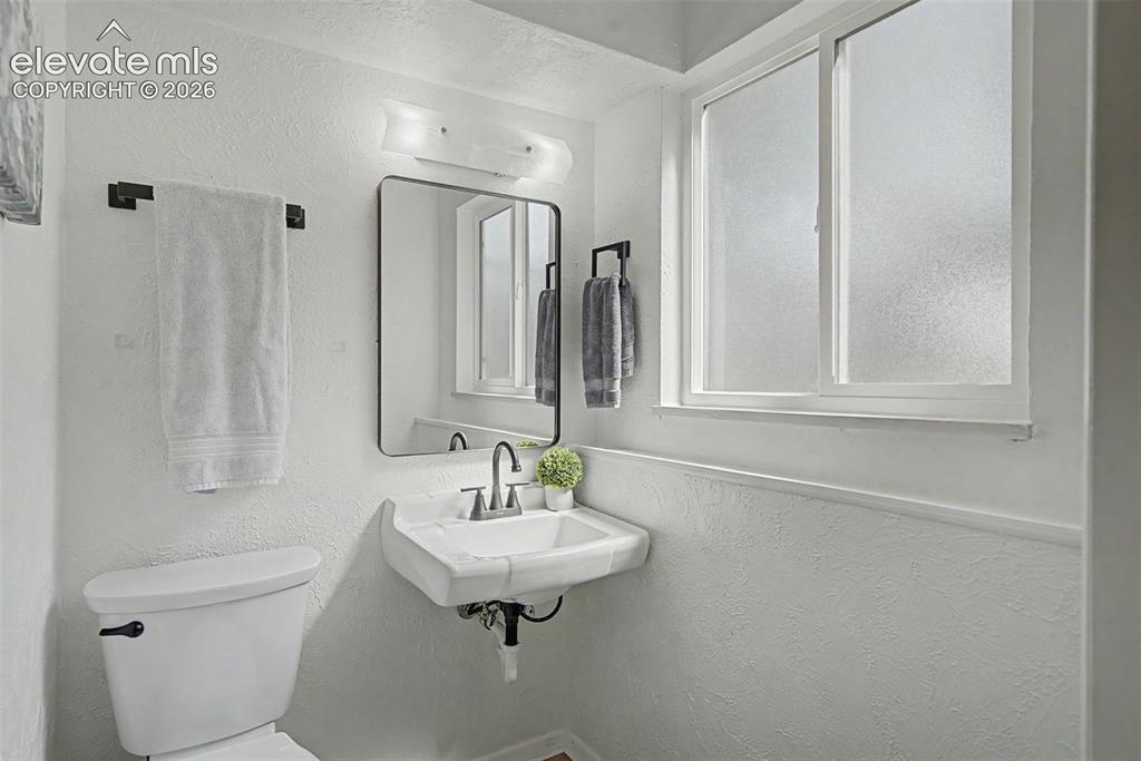Image 32 of 37: lower level half bath