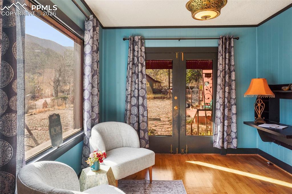 Image 23 of 47: Living area featuring a wealth of natural light, french doors, hardwood / w