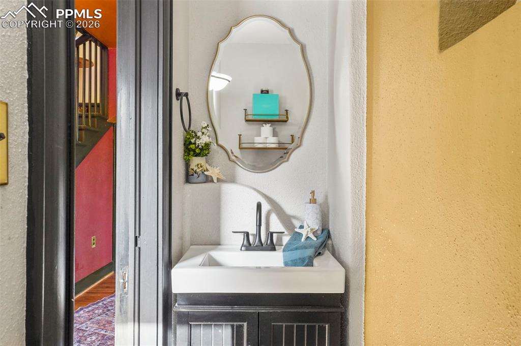 Image 24 of 47: 1/2 bathroom featuring vanity with built in nooks