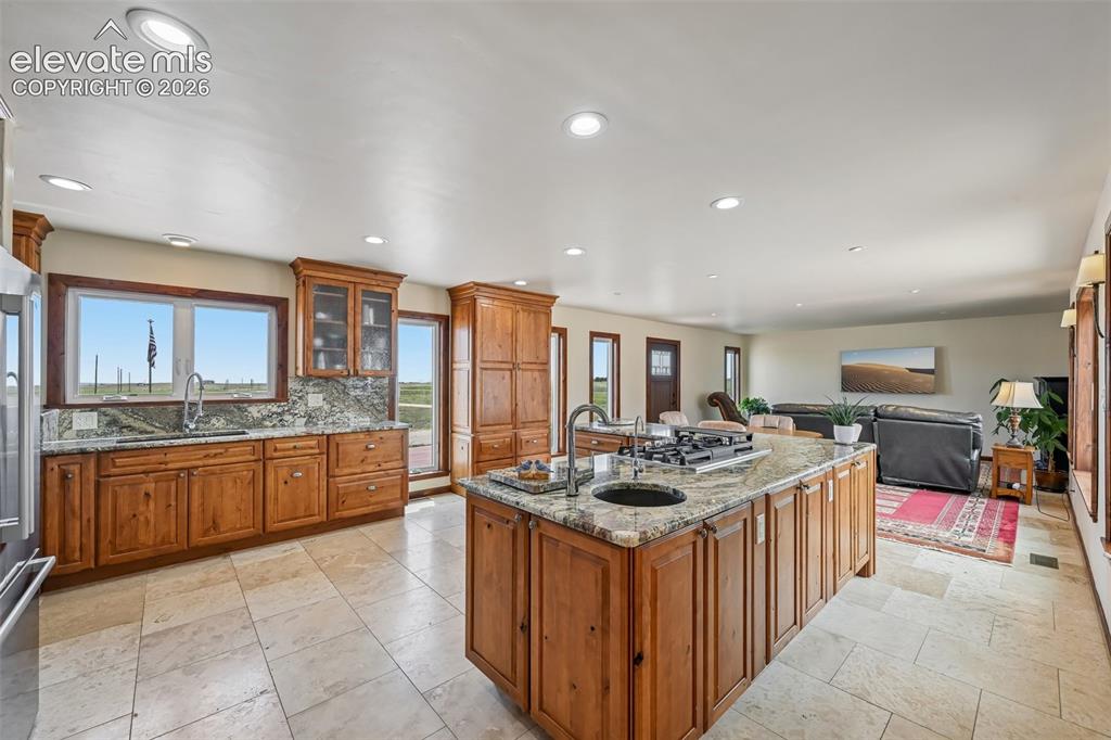 Image 11 of 36: Prep sink, filtered water dispenser and downdraft vent are in the island.