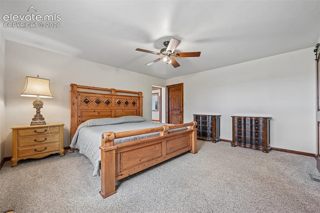 Image 18 of 36: Spacious room featuring neutral wall tones, textured carpeting, and a ceili