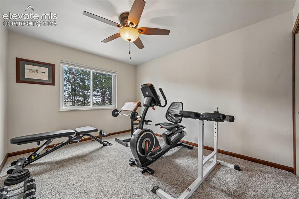 Image 20 of 36: Bedroom 2 being used as exercise area.