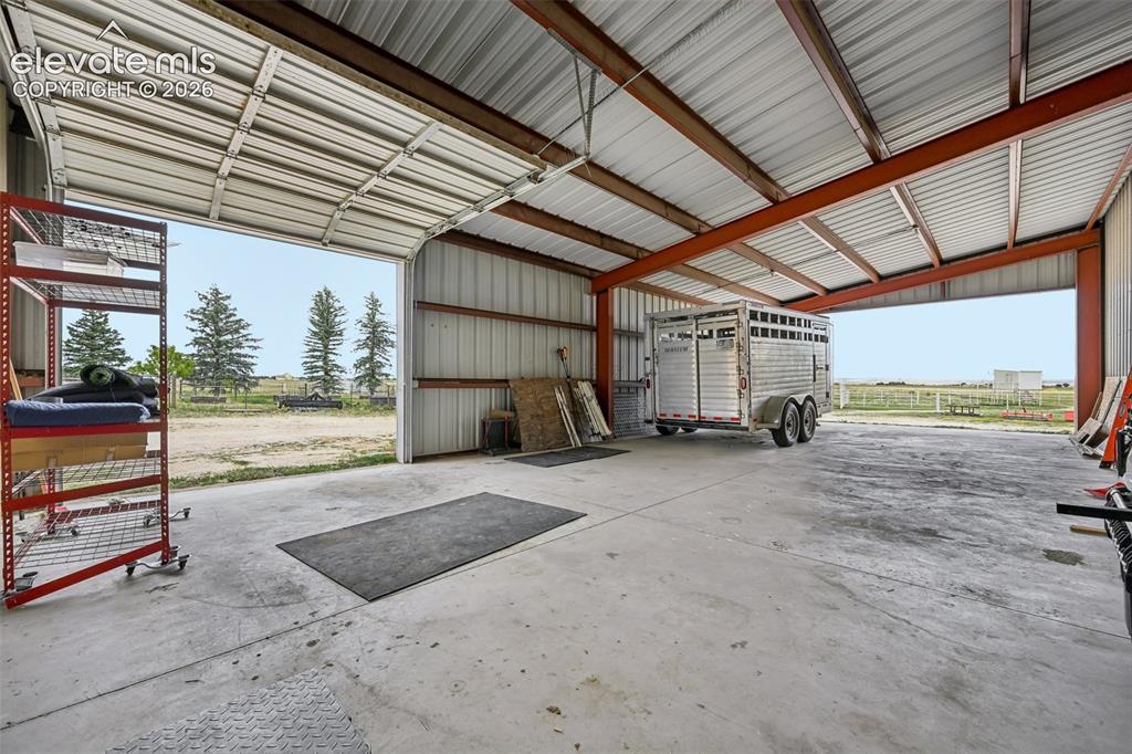 Image 33 of 36: Spacious utility building featuring a corrugated metal roof and walls, expo