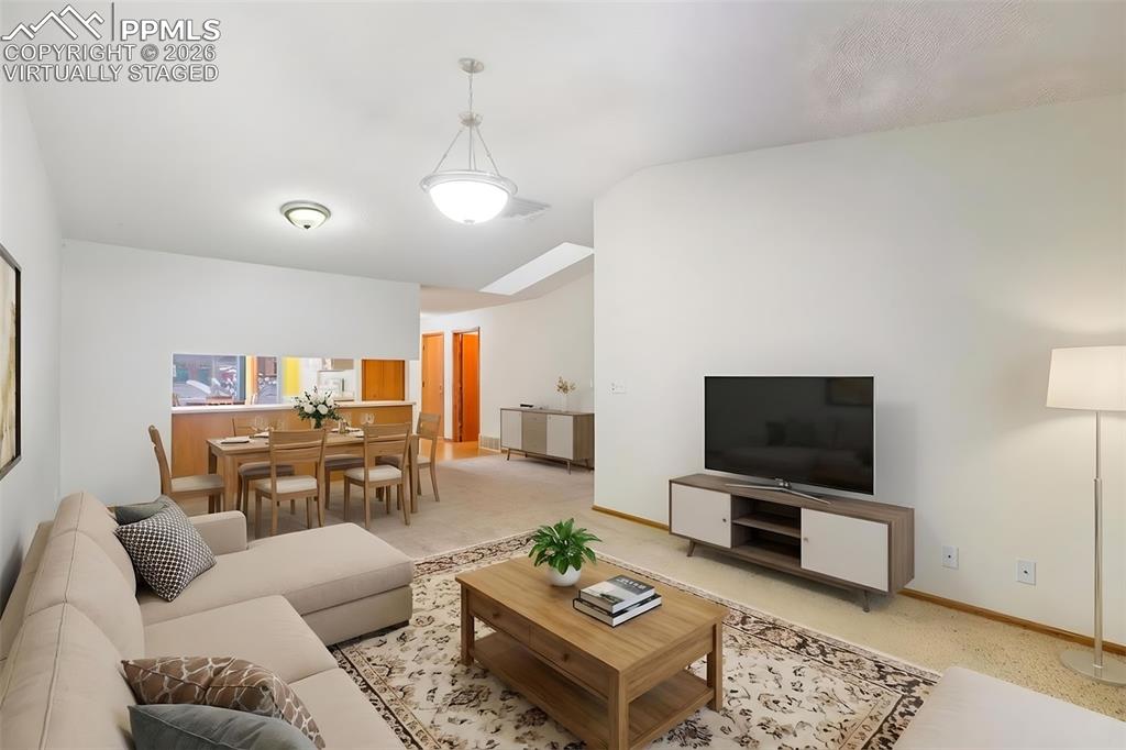 Image 11 of 30: Virtually Staged Living Area looking towards the dining area