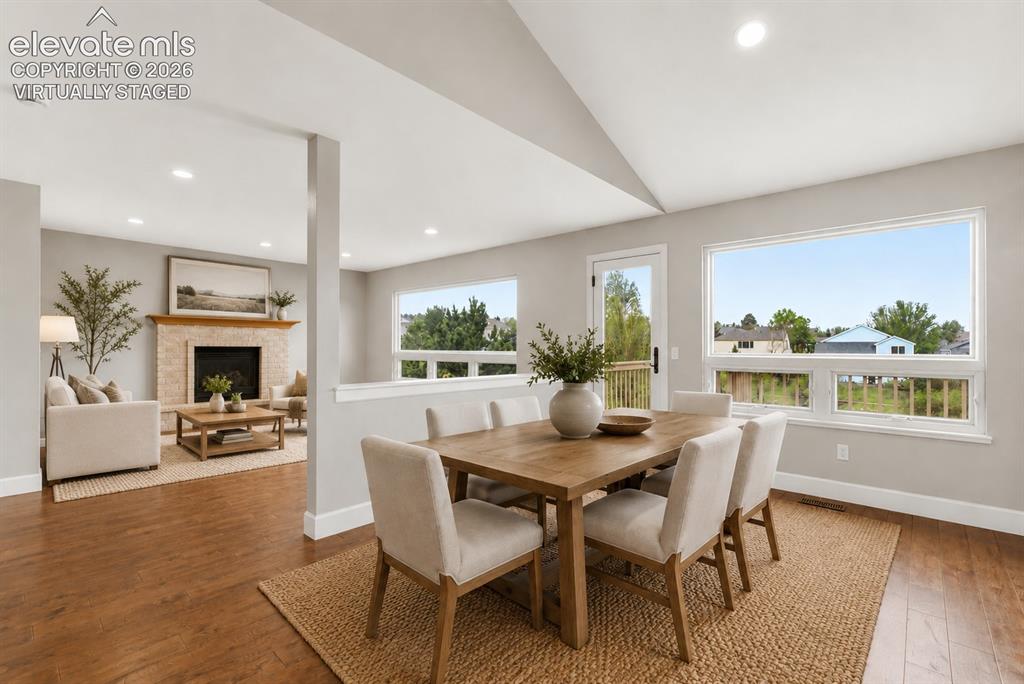 Image 22 of 50: Virtually Staged - Dining room with walkout to deck and amazing views