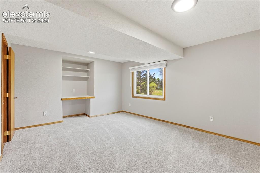 Image 45 of 50: 4th bedroom in basement with ensuite bath and built-in desk