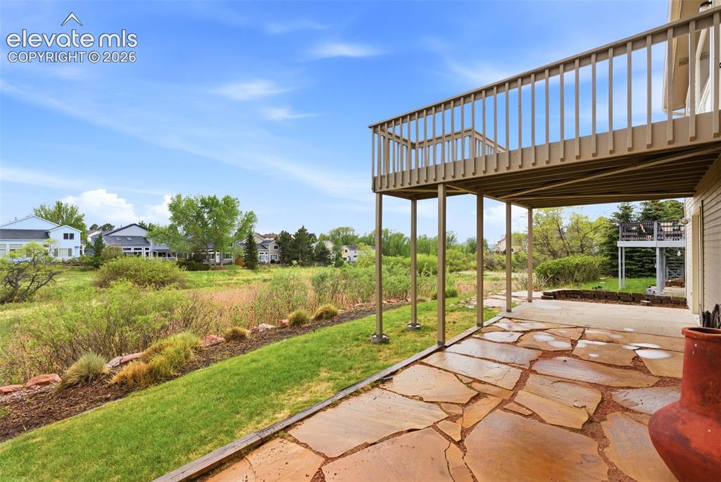 Image 9 of 50: Professionally landscaped with multiple outdoor living spaces
