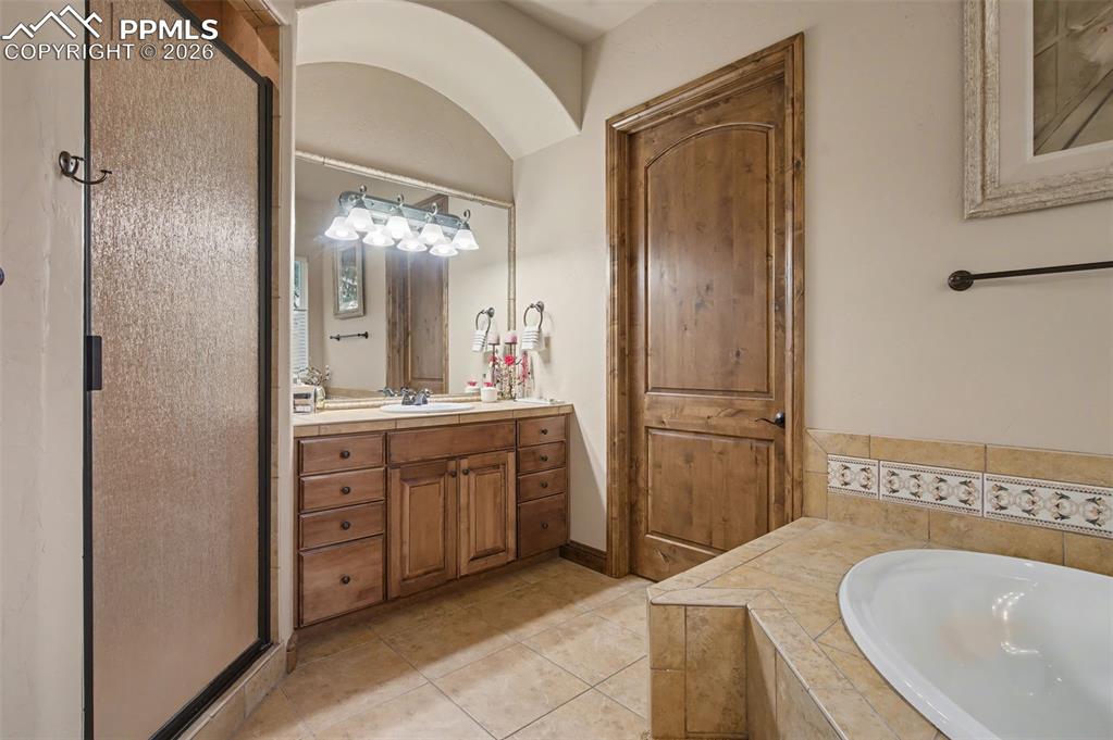 Image 20 of 42: A free-standing shower completes this private owner