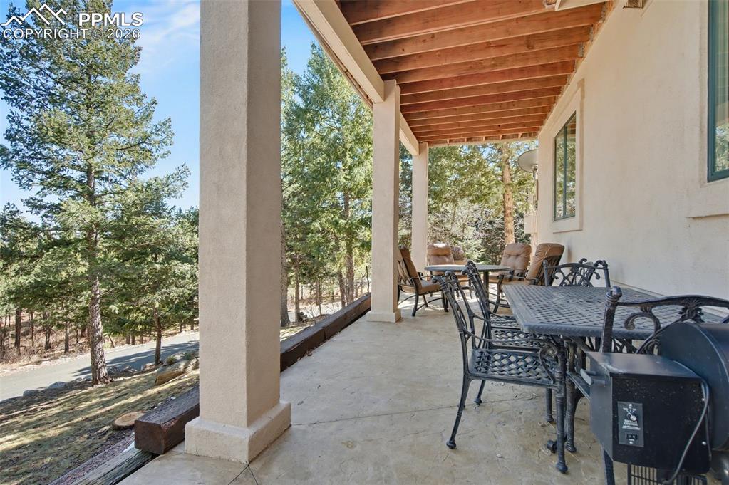 Image 32 of 42: Relax in the shade of the covered walkout patio and let the tranquility of 