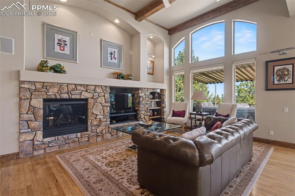 Image 7 of 42: Gather around the stunning stone finished, gas log fireplace for warm, rela