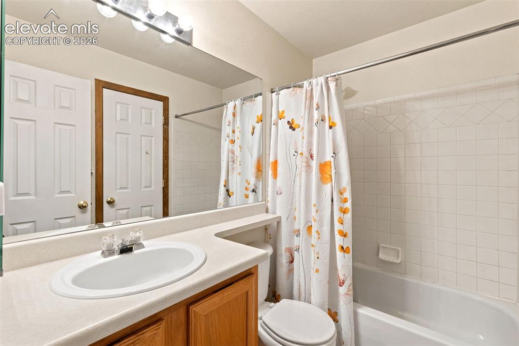 Image 14 of 34: Bathroom featuring a built-in vanity with an integrated sink, a white batht