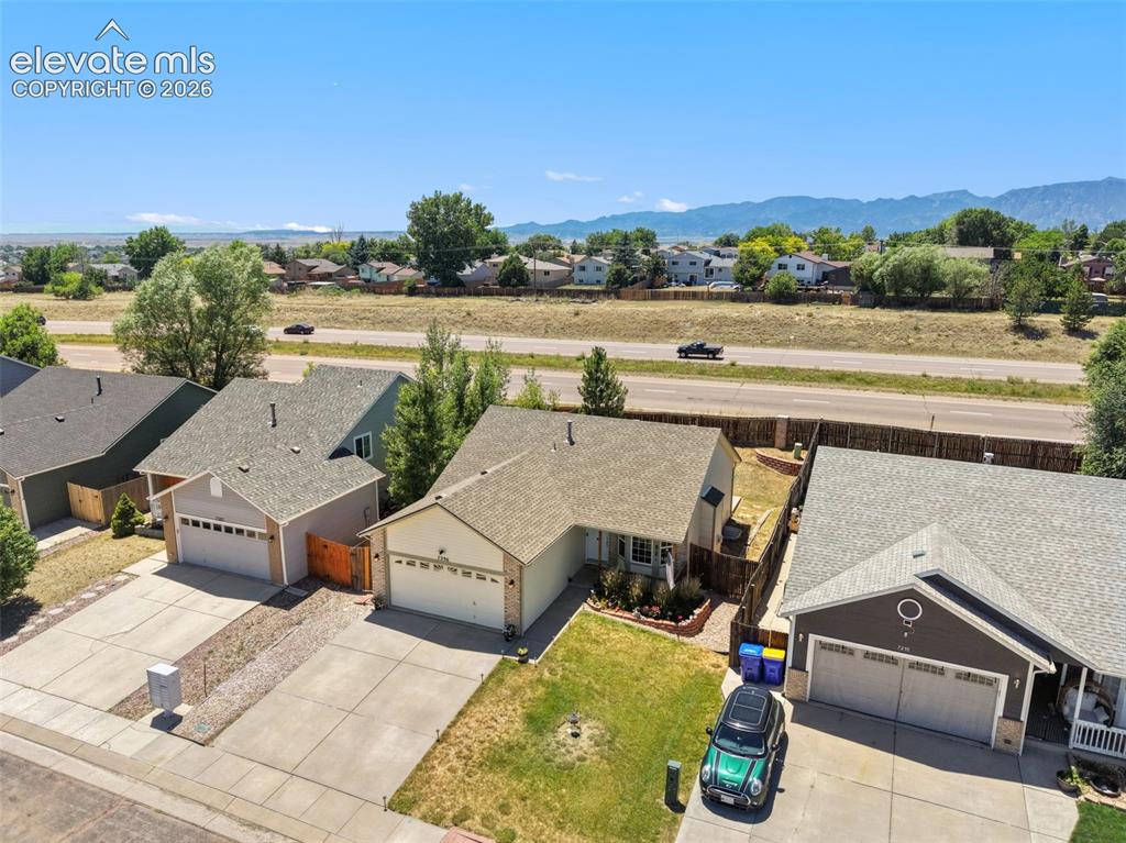 Image 28 of 34: Single-story residence featuring a two-car garage, concrete driveway, and a