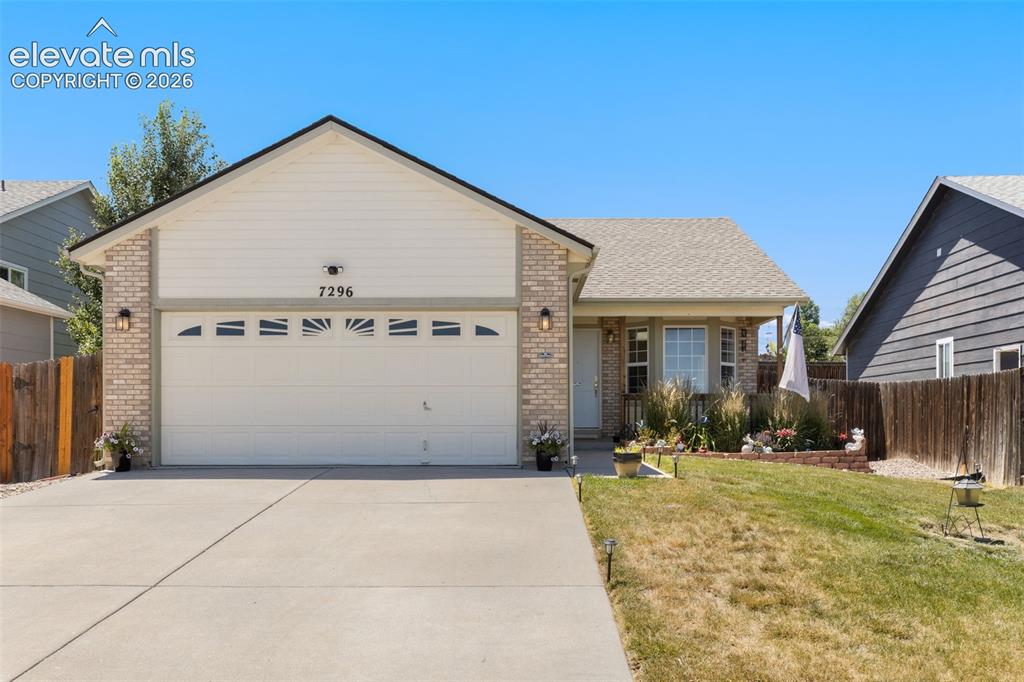 Image 34 of 34: Single-story residence featuring a two-car garage with transom-style window