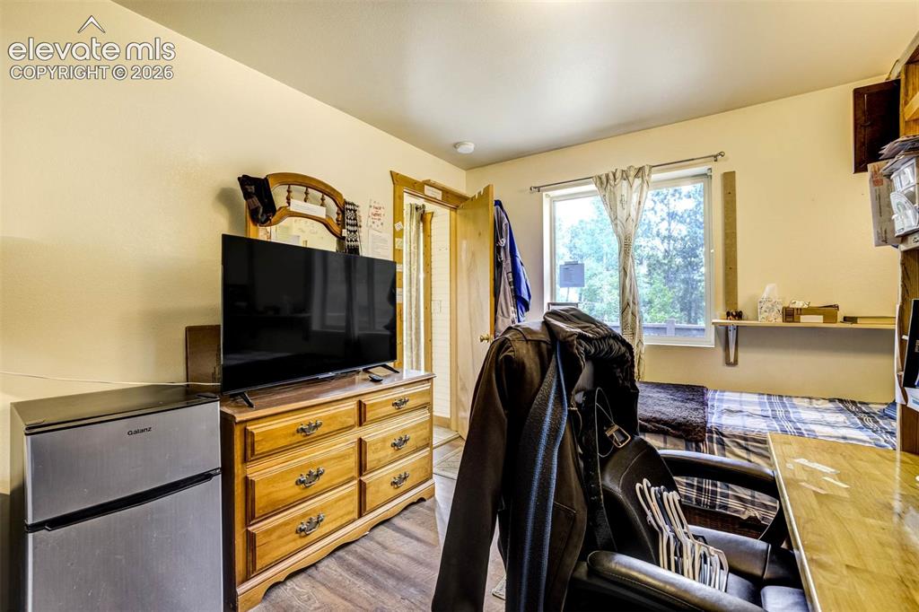Image 29 of 41: Bedroom has view of the trees in the back