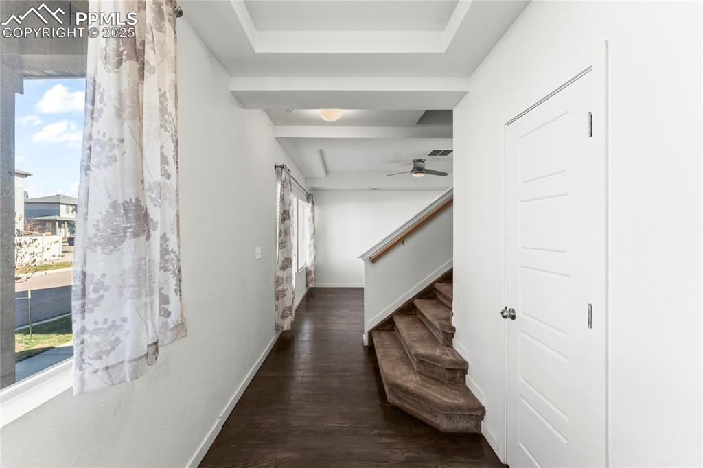 Image 2 of 33: Corridor with dark wood-type flooring, stairway, and a barn door