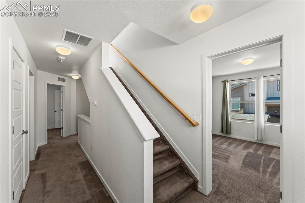 Image 21 of 33: Staircase with carpet and baseboards