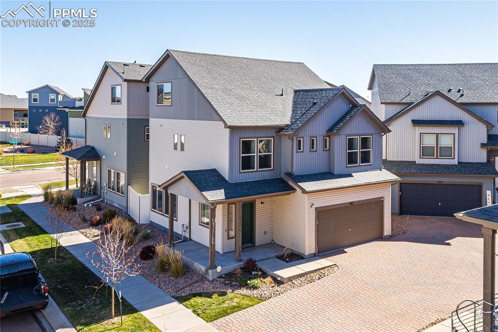 Image 25 of 33: View of front of property featuring a shingled roof, a porch, a residential