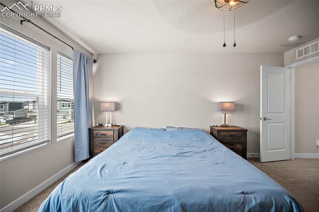 Image 21 of 41: Carpeted bedroom with baseboards and a ceiling fan