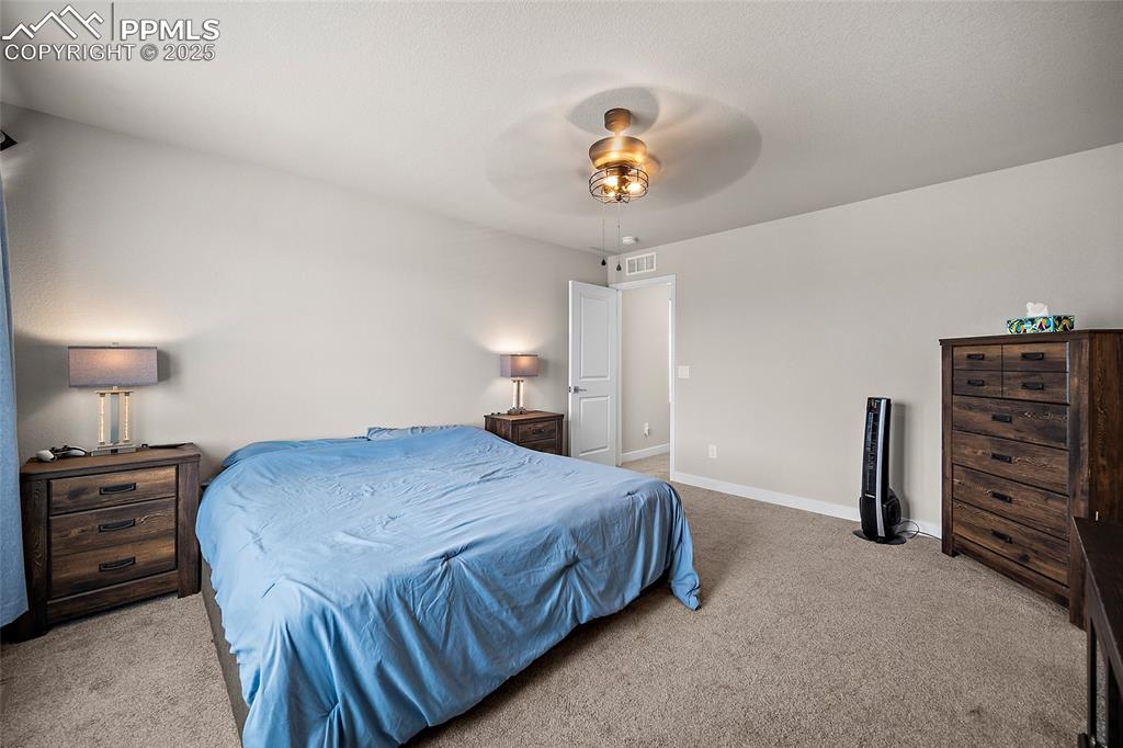 Image 22 of 41: Carpeted bedroom featuring baseboards and ceiling fan