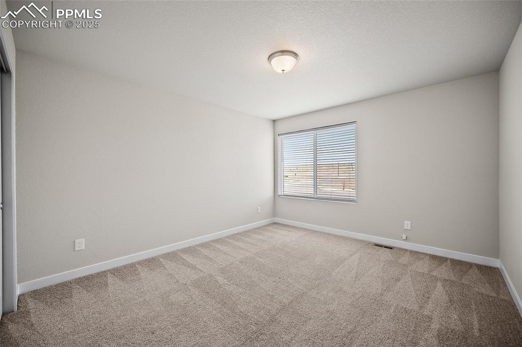 Image 29 of 41: Carpeted empty room with baseboards