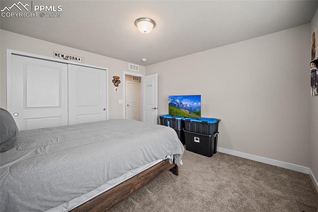 Image 34 of 41: Carpeted bedroom with baseboards and a closet
