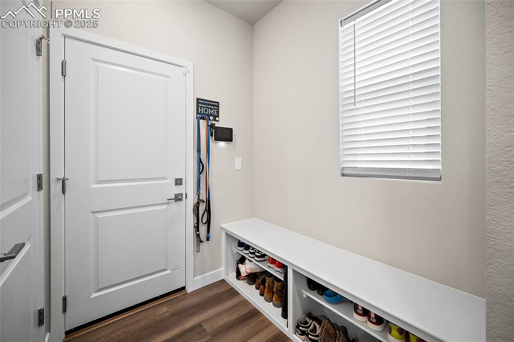 Image 35 of 41: Mudroom featuring dark wood-type flooring and baseboards