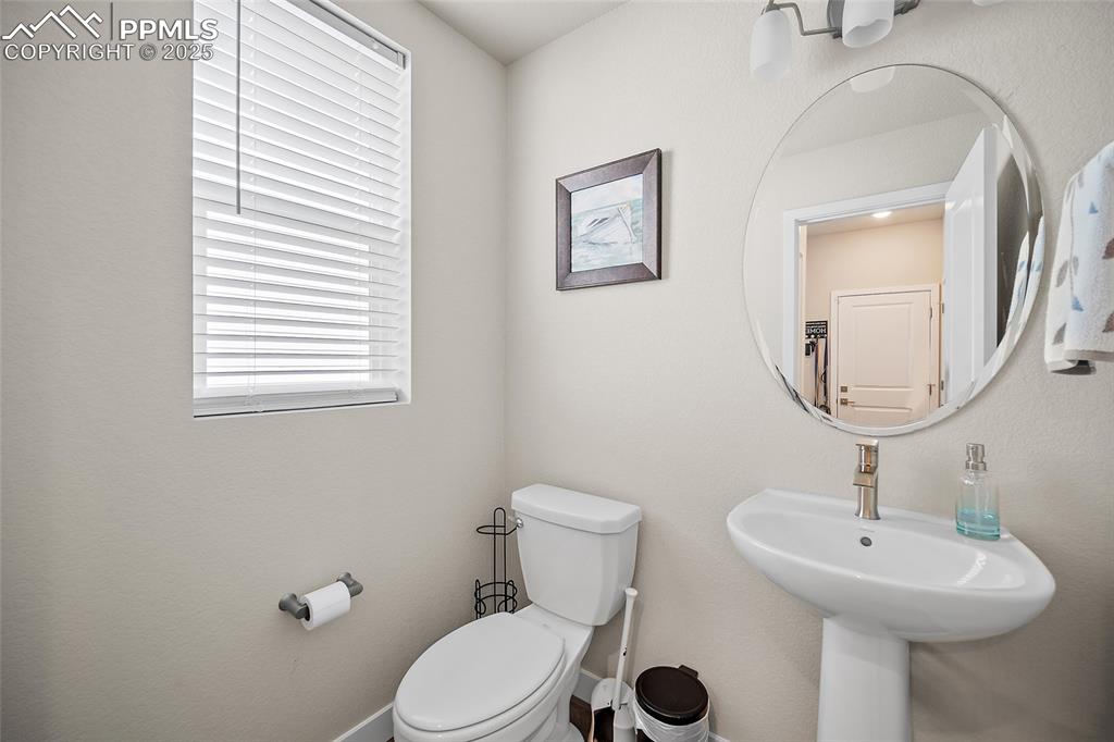 Image 36 of 41: Bathroom with toilet, baseboards, and a sink
