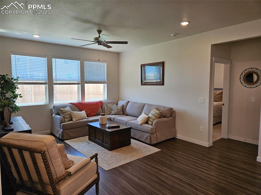 Image 13 of 42: Living room with a ceiling fan, dark wood-style flooring, recessed lighting
