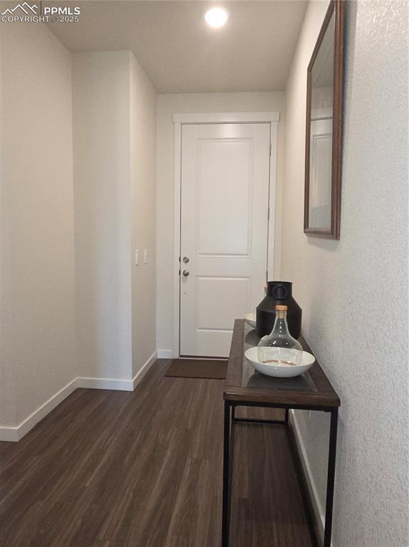 Image 2 of 42: Corridor with dark wood-style flooring and recessed lighting