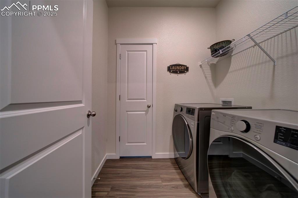 Image 24 of 42: Washroom with washing machine and dryer, and large storage closet