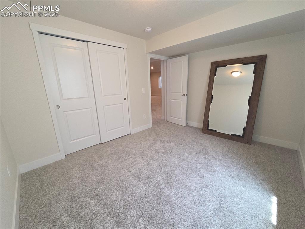 Image 30 of 42: Unfurnished bedroom with carpet flooring and a closet