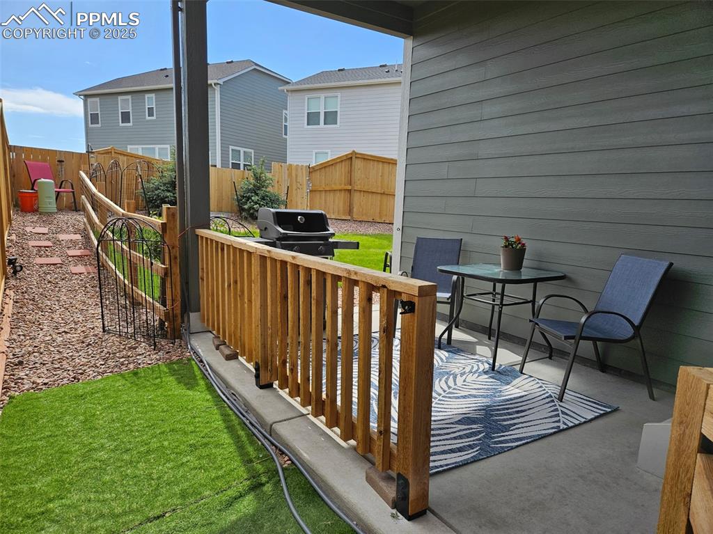 Image 36 of 42: Fenced backyard featuring a patio area