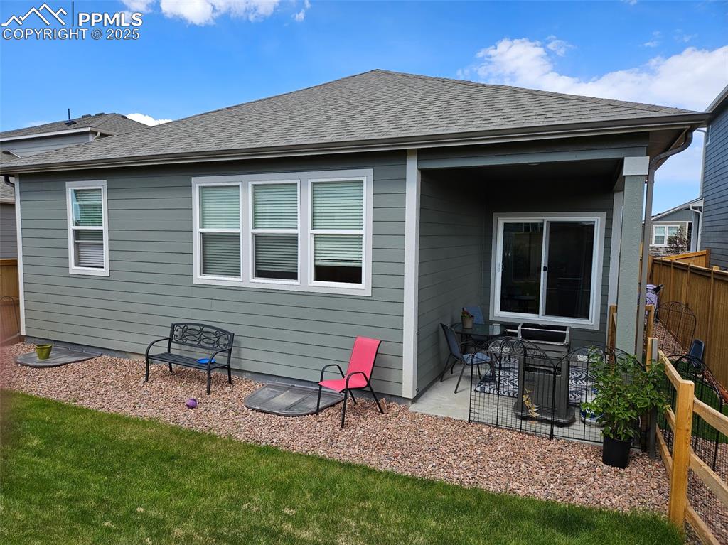 Image 40 of 42: Back of house featuring a patio area and roof with shingles