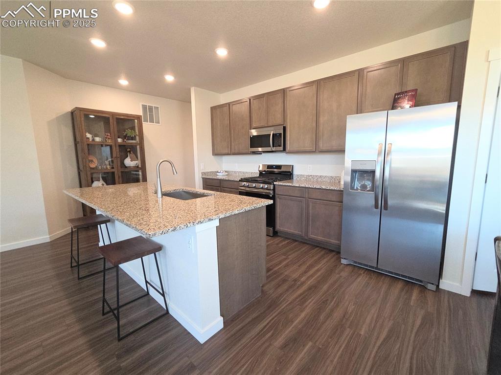 Image 5 of 42: Kitchen with appliances with stainless steel finishes, recessed lighting, d