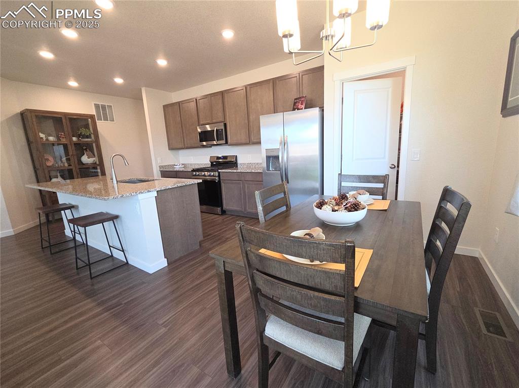 Image 6 of 42: Kitchen with stainless steel appliances, recessed lighting, a center island