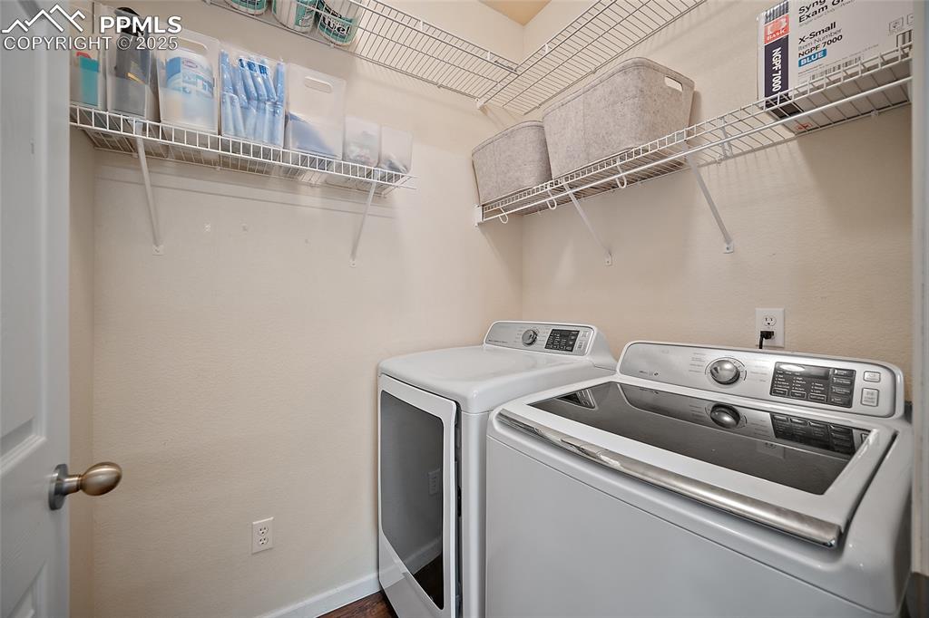 Image 14 of 50: Laundry room featuring washing machine and dryer and baseboards