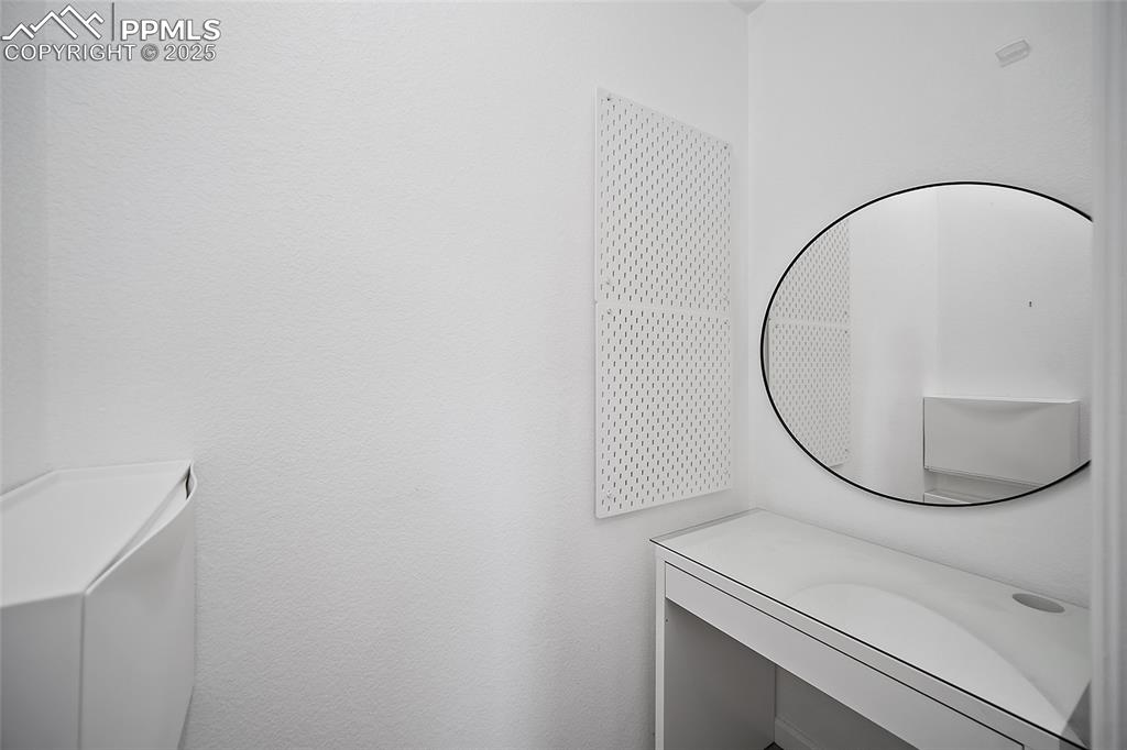 Image 25 of 50: Bathroom with vanity and a textured wall