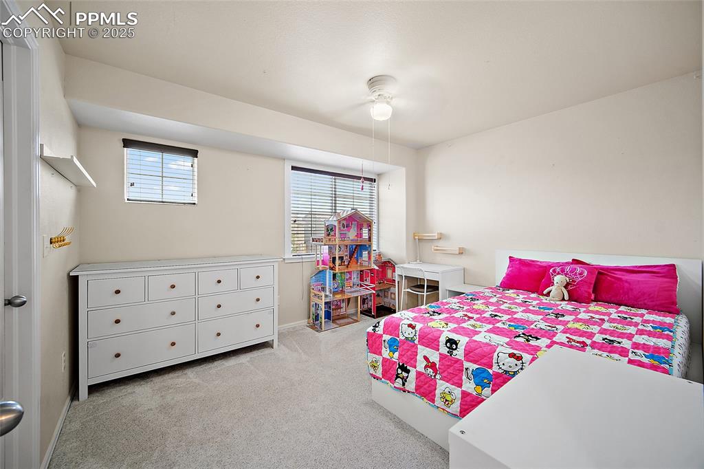 Image 29 of 50: Bedroom featuring light colored carpet and ceiling fan