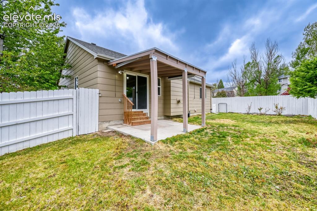 Image 39 of 47: Covered back patio, great for summer neighbirhood barbeques and family gath