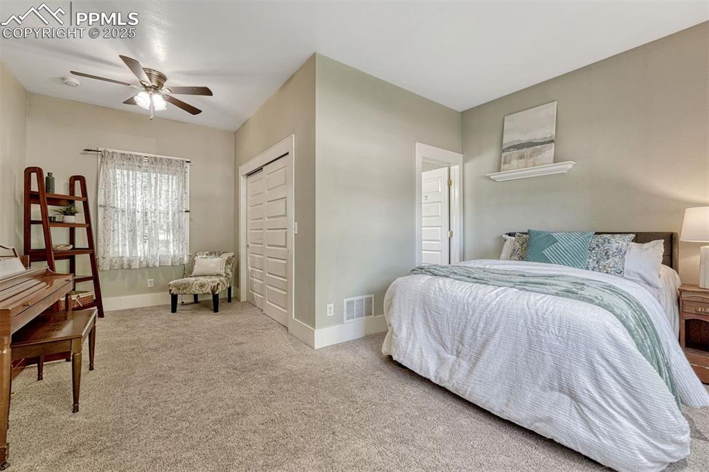 Image 4 of 42: Main level bedroom with attached 3/4 bath